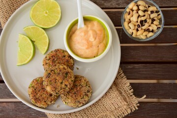 Delicious quinoa jalapeño bean burger patties with chili mayonnaise dip garnish with lime