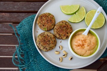Delicious quinoa jalapeño bean burger patties with chili mayonnaise dip garnish with lime