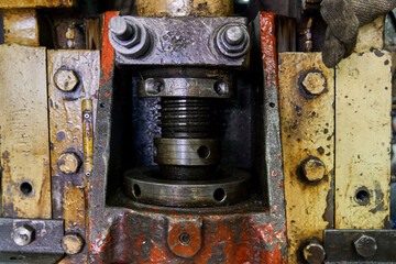 Closeup realistic in-used of heavy spiral screw in machine of automotive industry