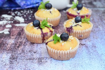 Blueberry coconut muffins garnish with mint leaves
