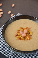 Borlotti bean or cranberry bean soup garnish with caramelized onion, chili and parsley