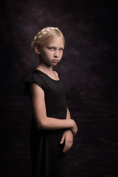 Classic studio portrait of blonde girl with braids in dark painterly Rembrandt style