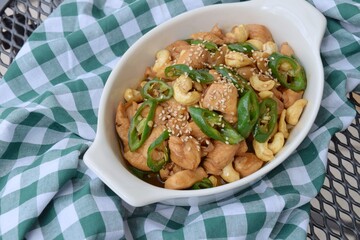 Stir-fried chicken with cashew nuts, green chili and sesame seeds