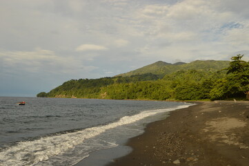 The lush jungle landscapes with waterfalls and black volcanic beaches on the St Vincent and...
