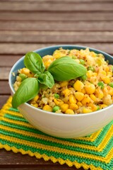 Cauliflower rice with corn and peas garnish with basil leaf