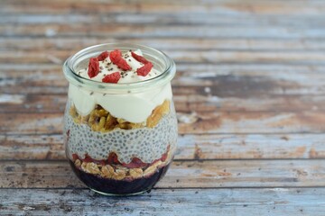 Chia breakfast pudding with walnut, goji berry, oat, yogurt and blackberry