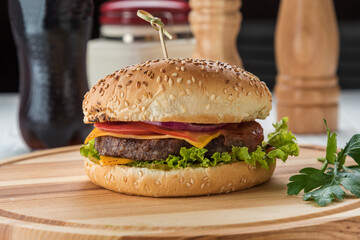 Burger on a cutting wooden board