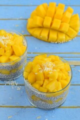 Coconut mango chia seed pudding. Blue background