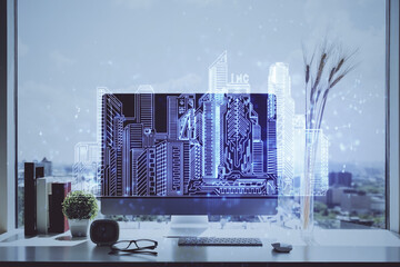 Desktop computer background in office and big town buildings hologram drawing. Double exposure. Smart city concept.
