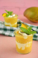 Mango baobab chia yogurt layer with mint leaf. Selective focus
