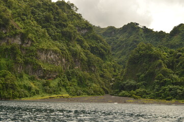 The lush jungle landscapes with waterfalls and black volcanic beaches on the St Vincent and...