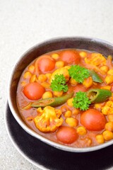 Spicy chickpea cauliflower tomato soup with green chili and parsley
