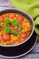 Spicy chickpea cauliflower tomato soup with green chili and parsley

