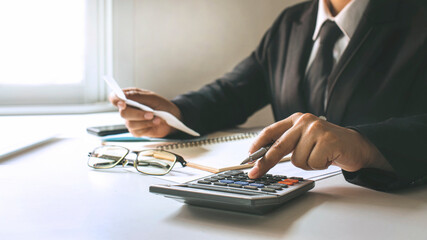 Finance workers are calculating company profits from charts on their desks at home, financial ideas and auditing.