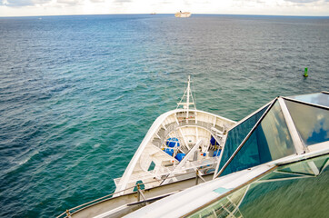 Luxury cruiseships or cruise ship liners sail towards horizon into Caribbean during twilight with...