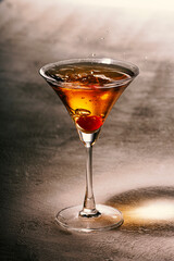 Alcoholic drink with ice on a light table, close up