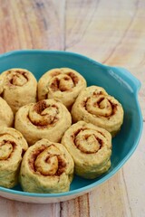 Raw cinnamon rolls prepared to bake
