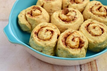 Raw cinnamon rolls prepared to bake
