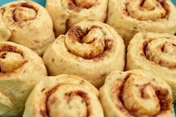 Raw cinnamon rolls prepared to bake
