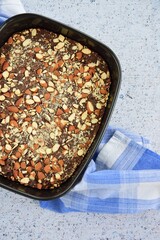 Chocolate cake brownie with almond in a baking pan
