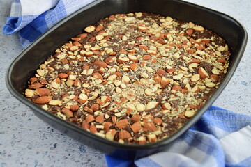 Chocolate cake brownie with almond in a baking pan