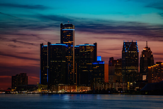 Close photo of night view of Detroit downtown skyscrapers and river from sunset point of Belle Isle, Michigan USA
