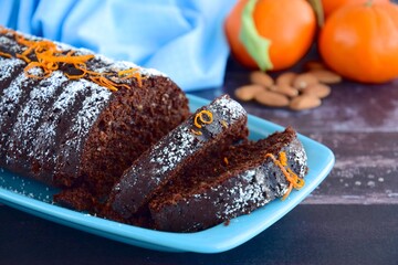 Chocolate almond clementine cake garnish with powdered sugar and zest