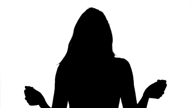 Silhouette. Excited woman dancing cheerfully over white background, medium shot.