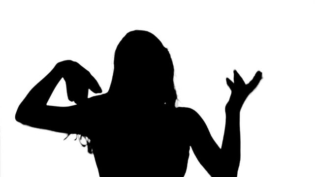 Silhouette. Excited woman dancing cheerfully overwhite background, medium shot.