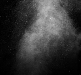 White vapour spray steam from air saturator. Smoke fragments on a black background. Abstract background