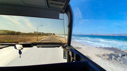 Admiring the beautiful Greek island of Kos through the window of a coach going along the coast.