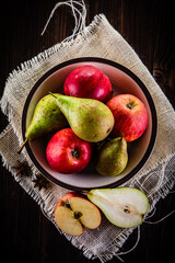 Autumn fruits - apples and pears on wooden table
