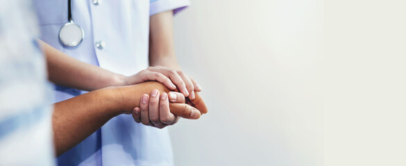 A nurse shaking hands to encourage the patient