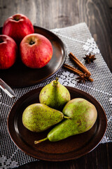 Autumn fruits - apples and pears on wooden table
