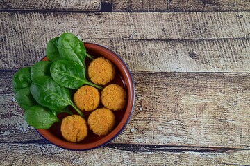 Traditional Lebanese food falafel with spinach, healthy vegan food. Wooden background. Flat lay,...