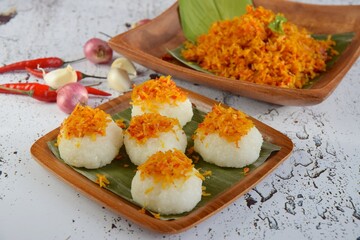 Ketan Serundeng. Indonesian cuisine. Savory steamed cake of glutinous rice with coconut milk, topped with spicy roasted desiccated coconut