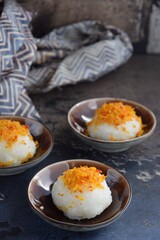 Ketan Serundeng. Indonesian cuisine. Savory steamed cake of glutinous rice with coconut milk, topped with spicy roasted desiccated coconut
