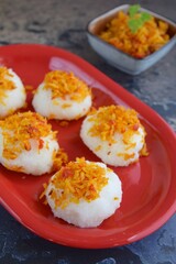 Ketan Serundeng. Indonesian cuisine. Savory steamed cake of glutinous rice with coconut milk, topped with spicy roasted desiccated coconut