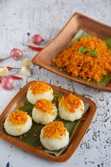 Ketan Serundeng. Indonesian cuisine. Savory steamed cake of glutinous rice with coconut milk, topped with spicy roasted desiccated coconut