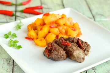Sambal goreng hati kentang or hot spicy liver and potatoes, Indonesian traditional cuisine served on plate. Typically served during Eid Al-Fitr celebration