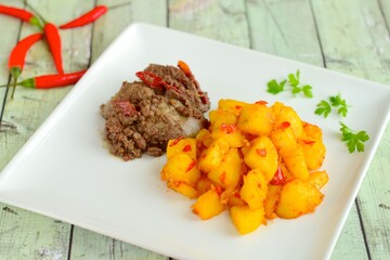 Sambal goreng hati kentang or hot spicy liver and potatoes, Indonesian traditional cuisine served on plate. Typically served during Eid Al-Fitr celebration