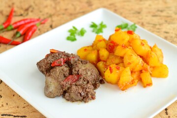 Sambal goreng hati kentang or hot spicy liver and potatoes, Indonesian traditional cuisine served on plate. Typically served during Eid Al-Fitr celebration