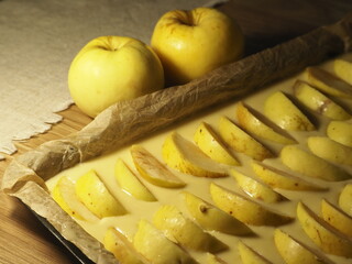 Apple pie and fresh apples prepared for baking
