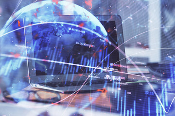 Financial market graph hologram and personal computer on background. Multi exposure. Concept of forex.