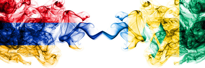 Armenia vs Saint Vincent and the Grenadines smoky mystic flags placed side by side. Thick colored silky abstract smoke flags
