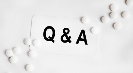 Q and A - Questions and Answers - sign through magnifying lens in doctor hands, medical questions concept