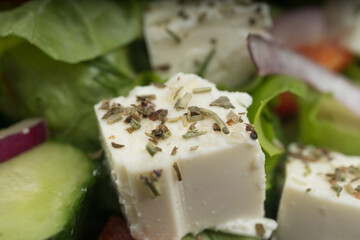 Delicious greek salad on a platter macro frame, close up