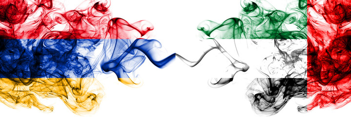 Armenia vs United Arab Emirates, Emirati smoky mystic flags placed side by side. Thick colored silky abstract smoke flags