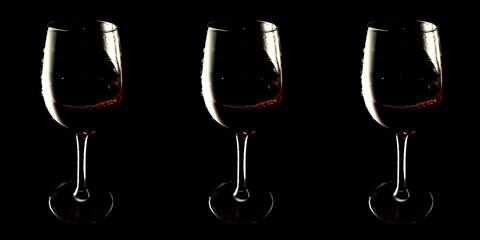 Banner glasses with red wine on black background vinotheque, copy space