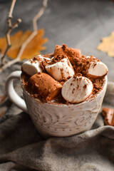 Hot chocolate and marshmallows. Hot Cocoa in a white cup. Dark background. Autumn drink concept. Copy space.